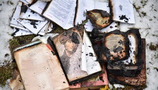 Journalists take pictures of the burnt UOC temple in Lvov