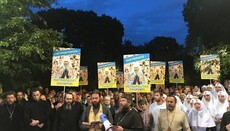 Believers hold a prayer standing at the residence of Phanar head in Kyiv